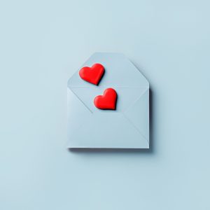 Love layout made with red hearts coming out of blue envelope on pastel background. Creative Valentine's Day, wedding, dating, spring or love concept. Flat lay.